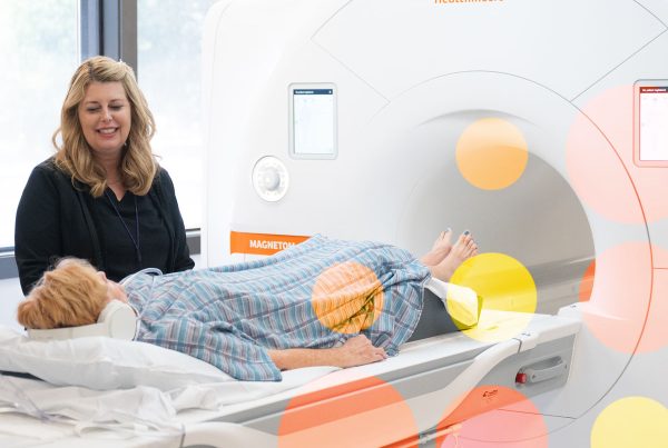 Lumina Imaging technologist assisting middle-aged woman before MRI scan at Westlake location.